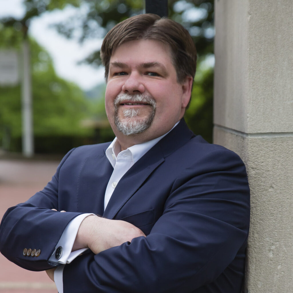 image of Christopher Stitt standing against a pillar
